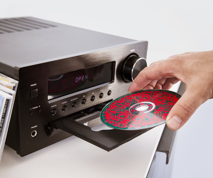 CD is inserted into an extended CD deck.