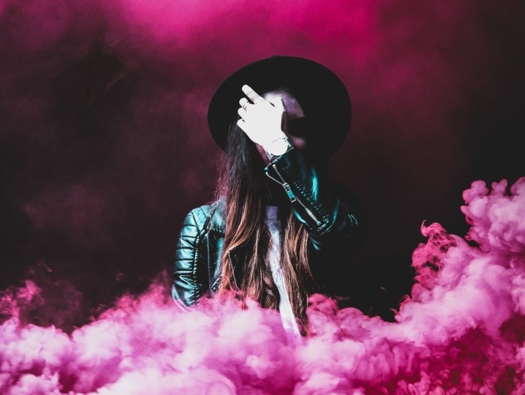 Indie-rock fan surrounded by pink smoke